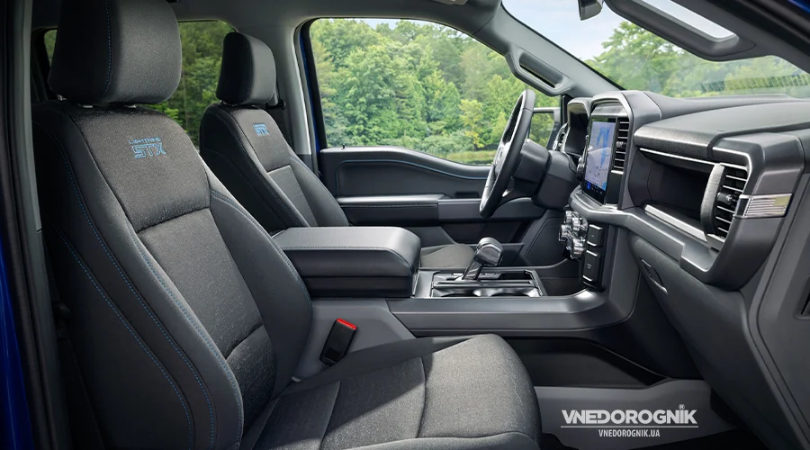 The pickup's interior with cloth seats, blue accents, and embroidered STX logos.