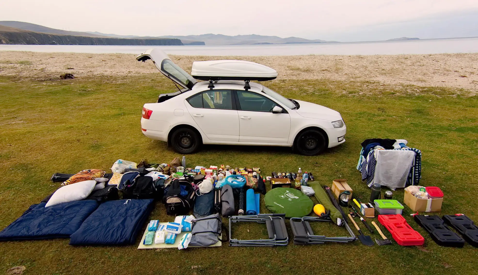 Спорядження для автотуризму розкладене біля автомобіля